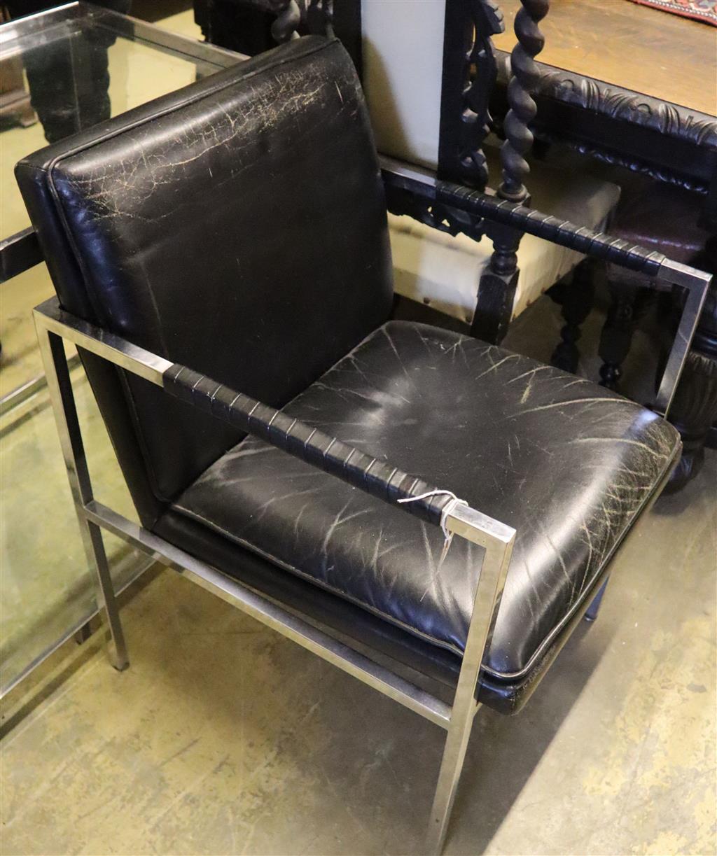 A contemporary chrome and black leather elbow chair